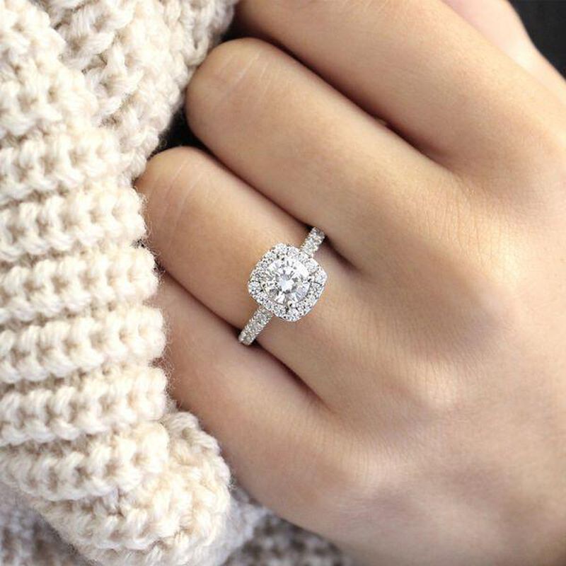 A detailed pave setting with diamonds that lace the band and halo. This contemporary styled ring is truly enchanting.   image number null